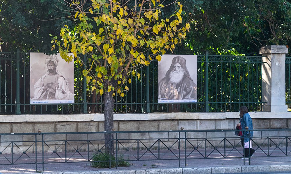 View of the outdoor exhibition. The portraits depict a blind man in Syros (left) and Neophytos Metaxas (right)